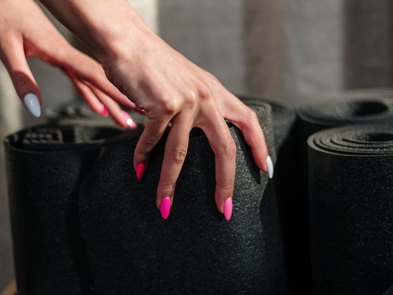 Detailed close-up of a yoga practitioner's hands.